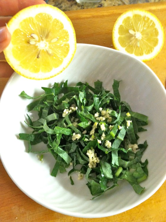 Once the garlic is in, squeeze enough lemon to coat all the leaves
