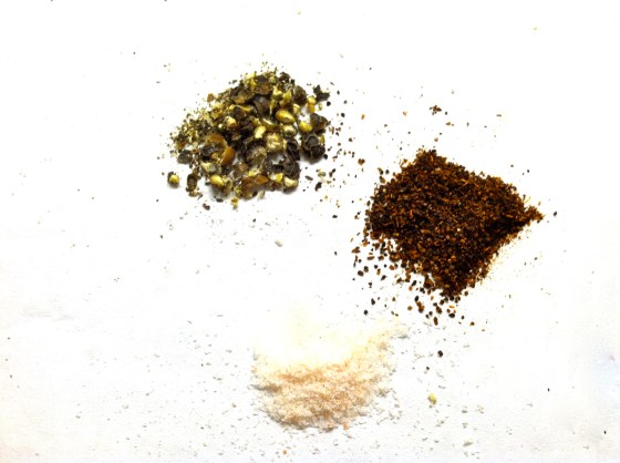 Next, add freshly ground black pepper, chili powder, and salt